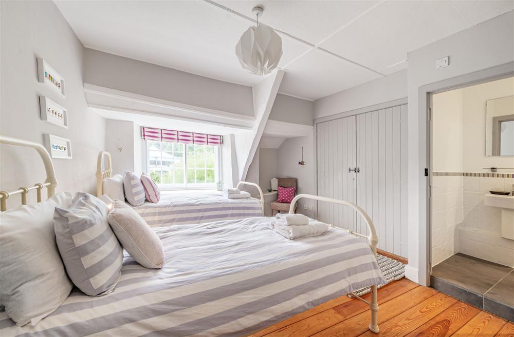 Bedroom five with twin beds and en-suite shower room at Albury House, Charmouth