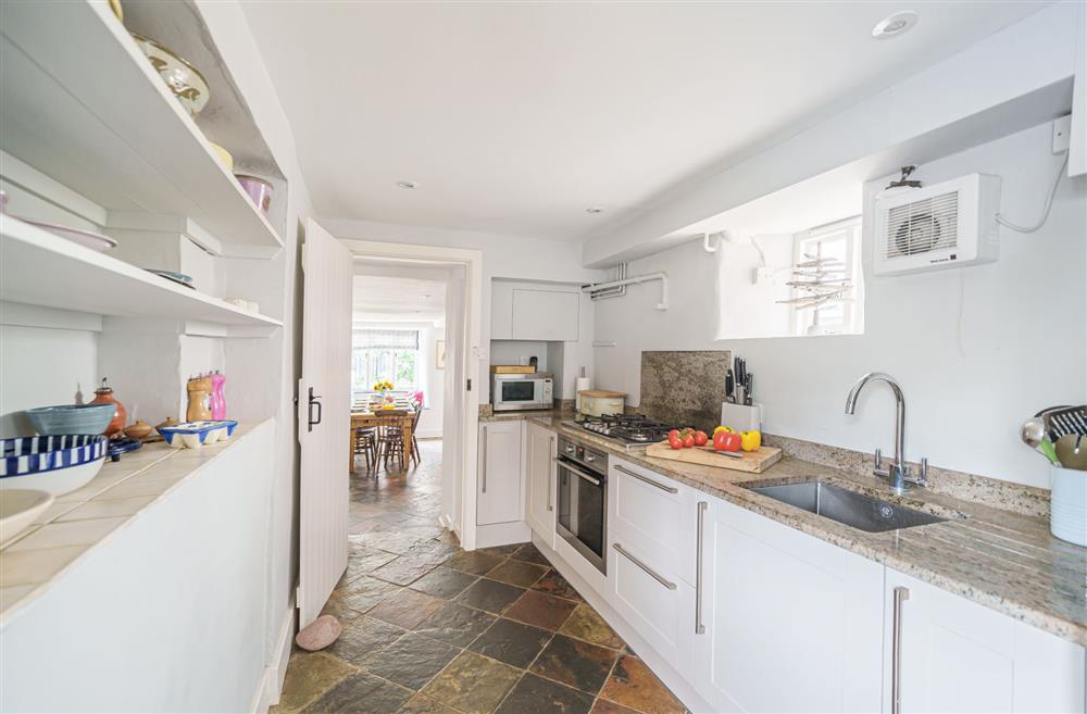The kitchen extends with a galley style prep area with second sink at Albury House, Charmouth