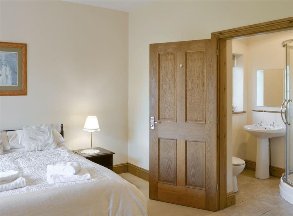 Comfortable double bedroom with en-suite shower room at Alby Bungalow in Cumwhinton, Carlisle, Cumbria
