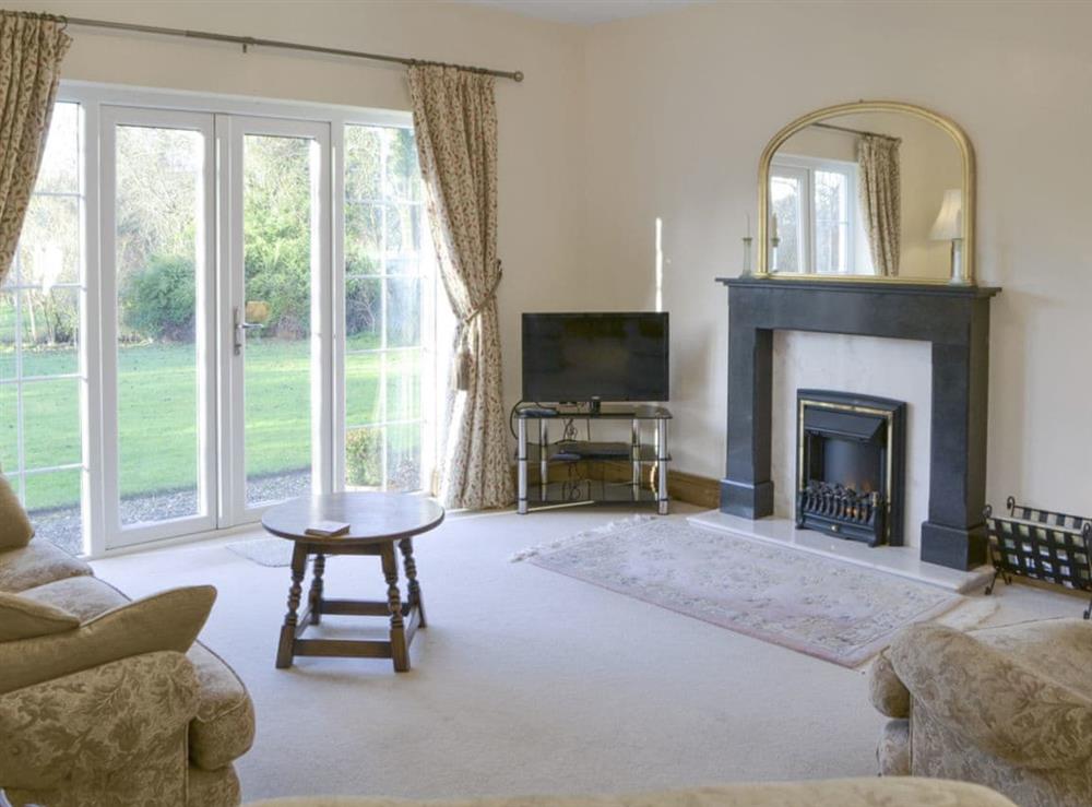 Spacious living area with French doors to garden at Alby Bungalow in Cumwhinton, Carlisle, Cumbria