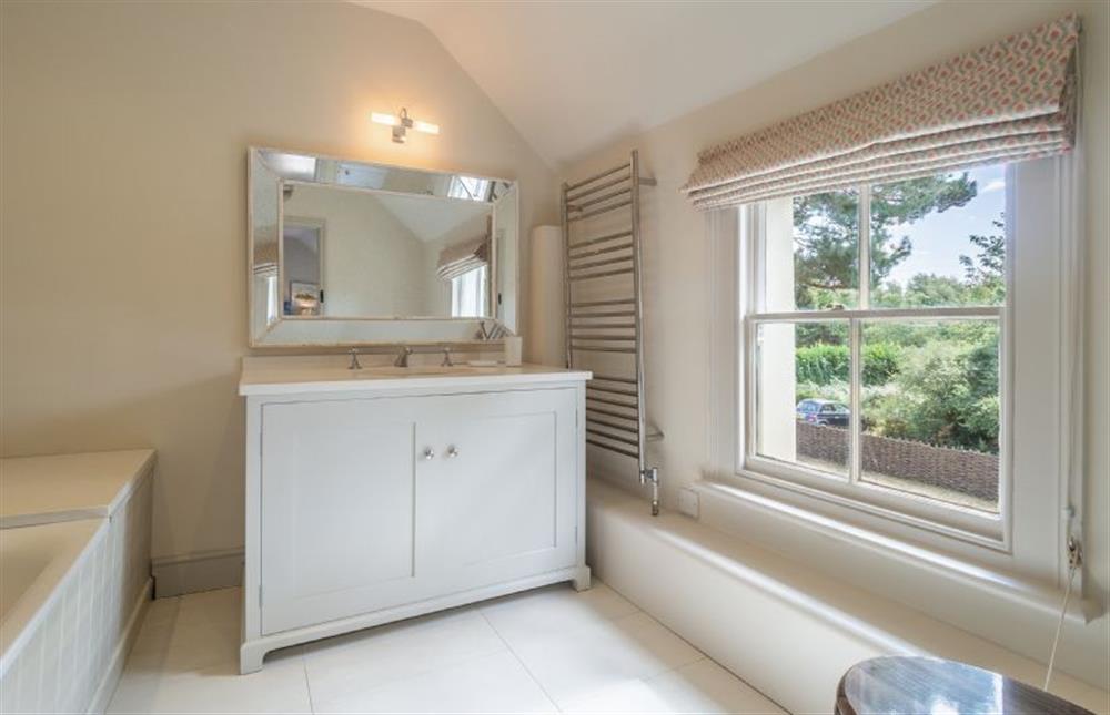 En-suite bathroom with bath with rainfall shower over, wash basin and WC at Alexander House, Thorpeness