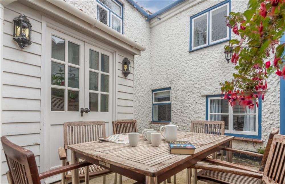 Rear courtyard garden with table with seating for six at Algerine Cottage, Wells-next-the-Sea