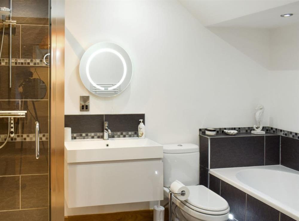 Family bathroom with bath and separate shower cubicle at Alices Place in Whitby, North Yorkshire