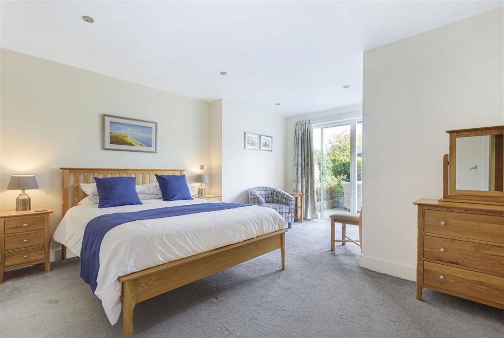 All Views, Dorset: Bedroom five with a 5ft king-size bed and french doors to the garden at All Views, Bridport