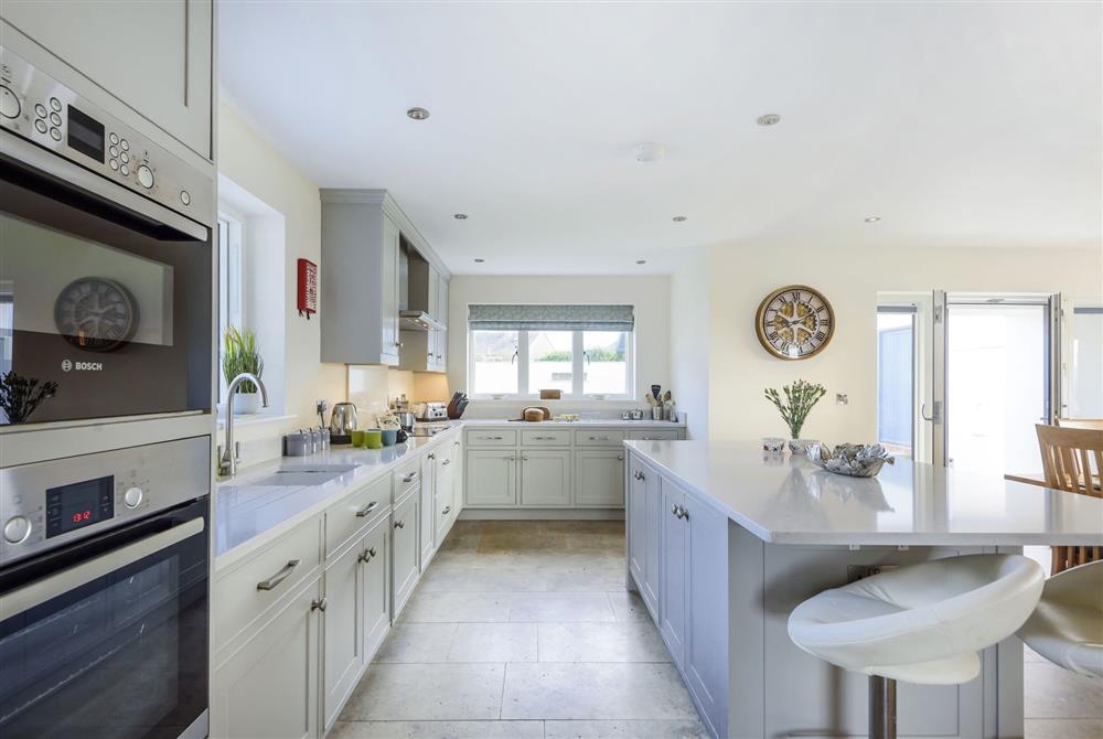 All Views, Dorset: The spacious and well-equipped kitchen with island, wine fridge and bar stools at All Views, Bridport