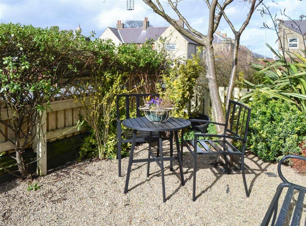 Bistro style table and chairs in the secluded front garden at Alnwick Cottage in Alnwick, Northumberland