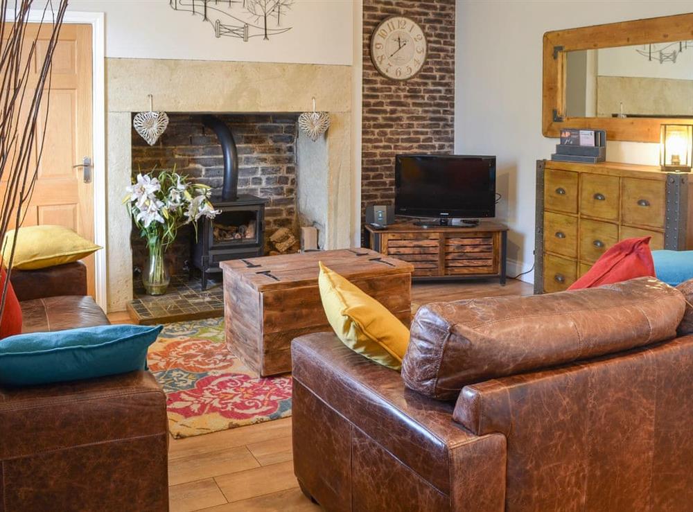 Charming and homely living room with open fireplace at Alnwick Cottage in Alnwick, Northumberland