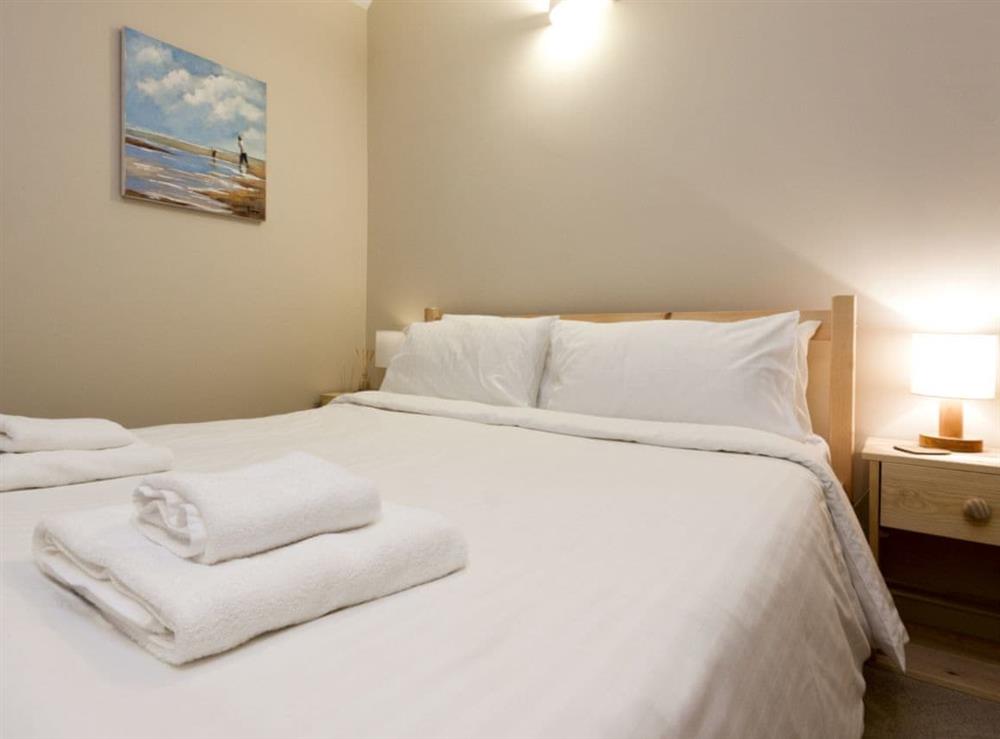 Spacious bedroom with kingsize bed and small bunk bed at Aloft in Salcombe, Devon