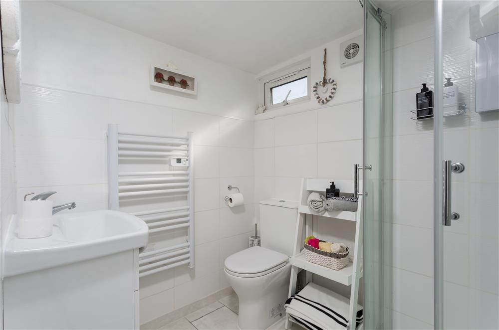 Crisp, white bathroom with heated towel rail at Alpaca Lodge, Burford