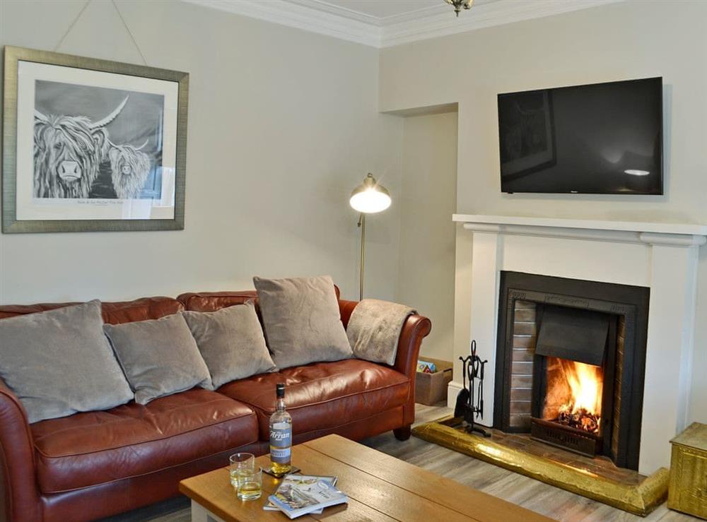 Beautifully presented living room with open fire at Altbeg in Isle of Arran, Scotland