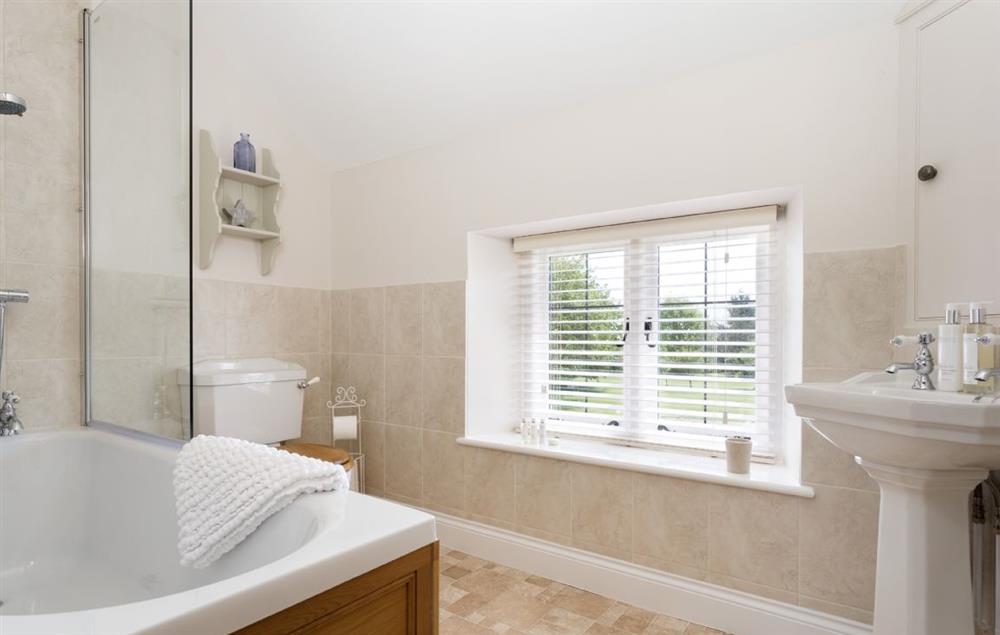 Family bathroom with bath and shower over at Alysas Cottage, Chipping Norton