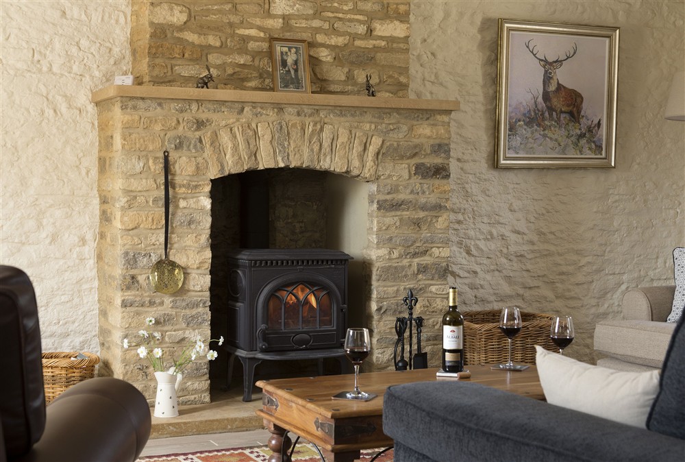 Sitting room with cosy wood burning stove (photo 2) at Alysas Cottage, Chipping Norton