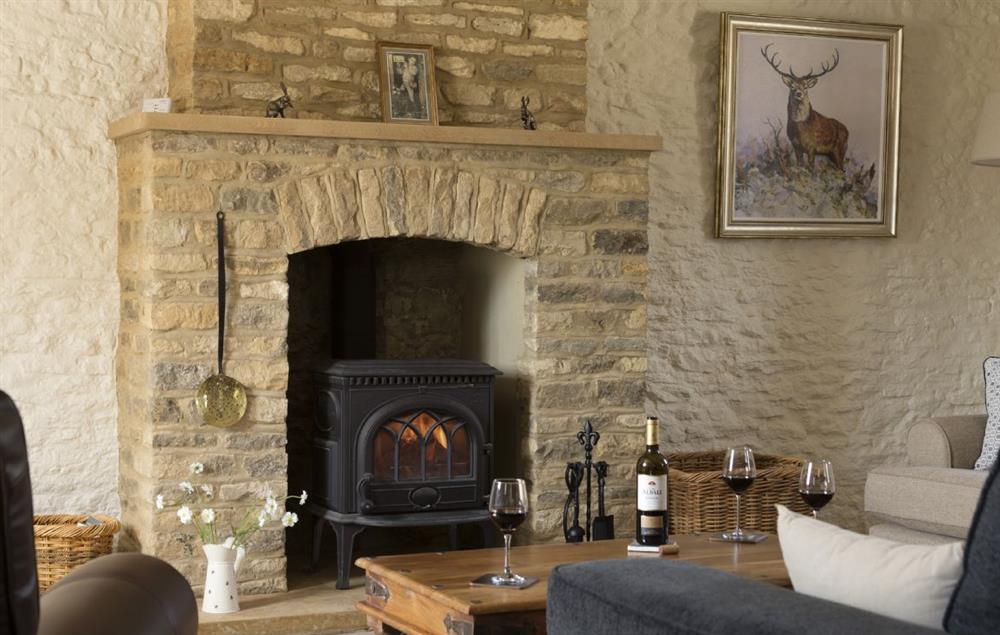 Sitting room with cosy wood burning stove at Alysas Cottage, Chipping Norton