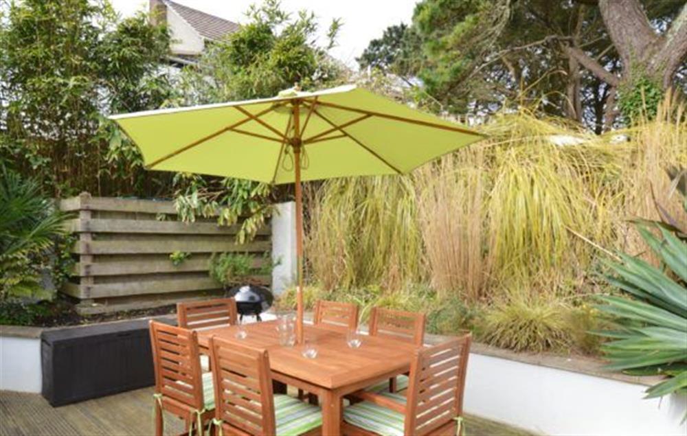 A spacious garden with decked area, garden furniture and barbecue at Amaroo, St Agnes