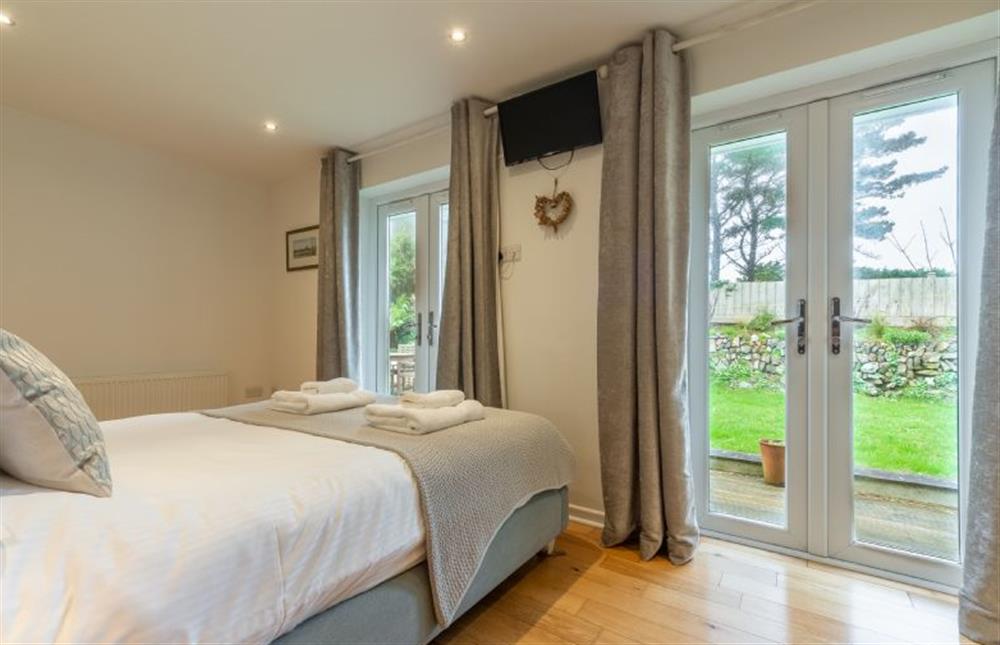 Amaroo, Cornwall: Bedroom one with doors to garden at Amaroo, St Agnes