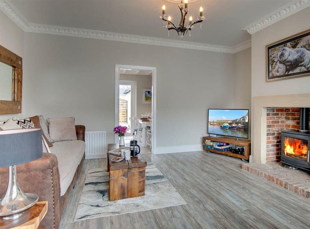 Tastefully furnished living room with wood burner (photo 2) at Amber Waves in Seahouses, near Alnwick, Northumberland