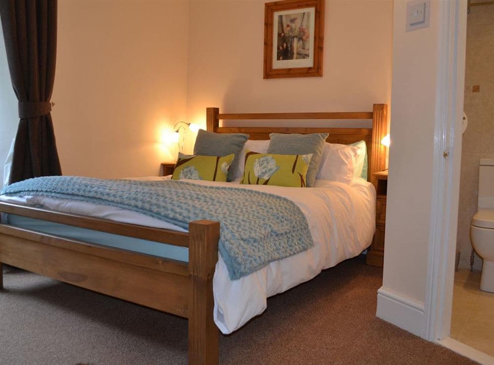 Stylish double bedroom with en-suite shower room at Amberleigh House in Windermere, Cumbria