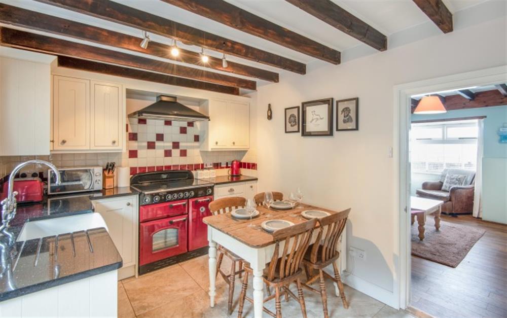 A large range style cooker sits at the heart of the pretty kitchen at Anchor Cottage in Beesands