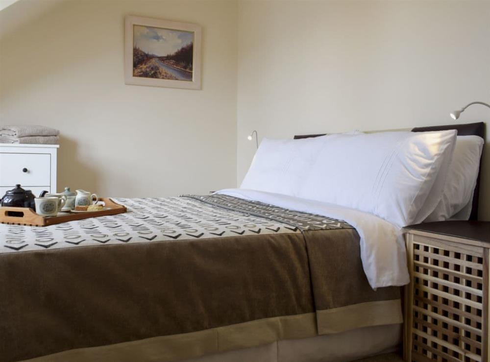 Comfortable double bedroom with sloping ceilings at Anchor Cottage in Pittenweem, near Anstruther, Fife