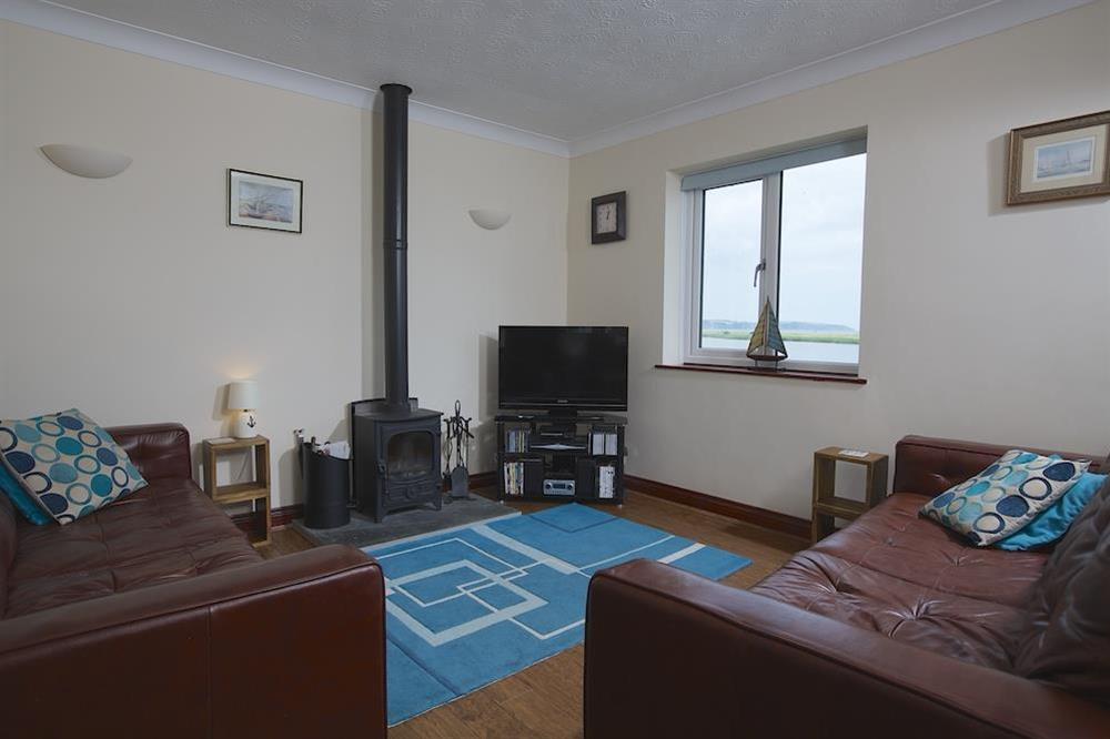 Lounge with wood burning stove and views over the Ley at Anchor Ley in Torcross, Kingsbridge