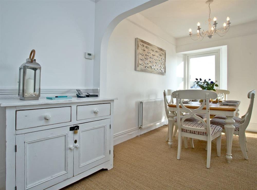 Modest dining area with shabby chic table and chairs at Anchor Loft in Fowey, Cornwall