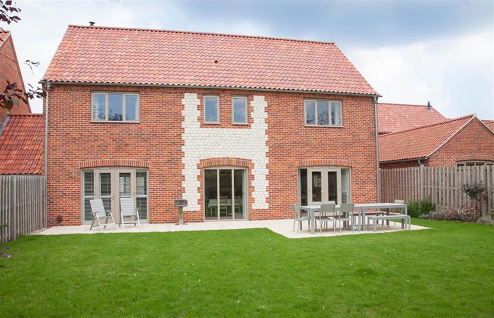Anchorage:  Rear elevation with enclosed garden and patio at Anchorage, Brancaster near Kings Lynn