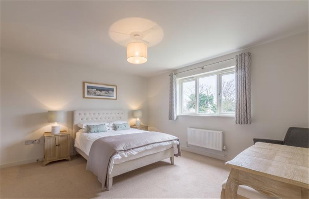 First floor:  Master bedroom with king-size bed at Anchorage, Brancaster near Kings Lynn