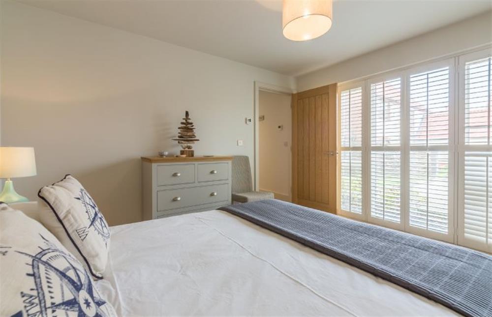 Ground floor: Bedroom three with king-size bed at Anchorage, Brancaster near Kings Lynn