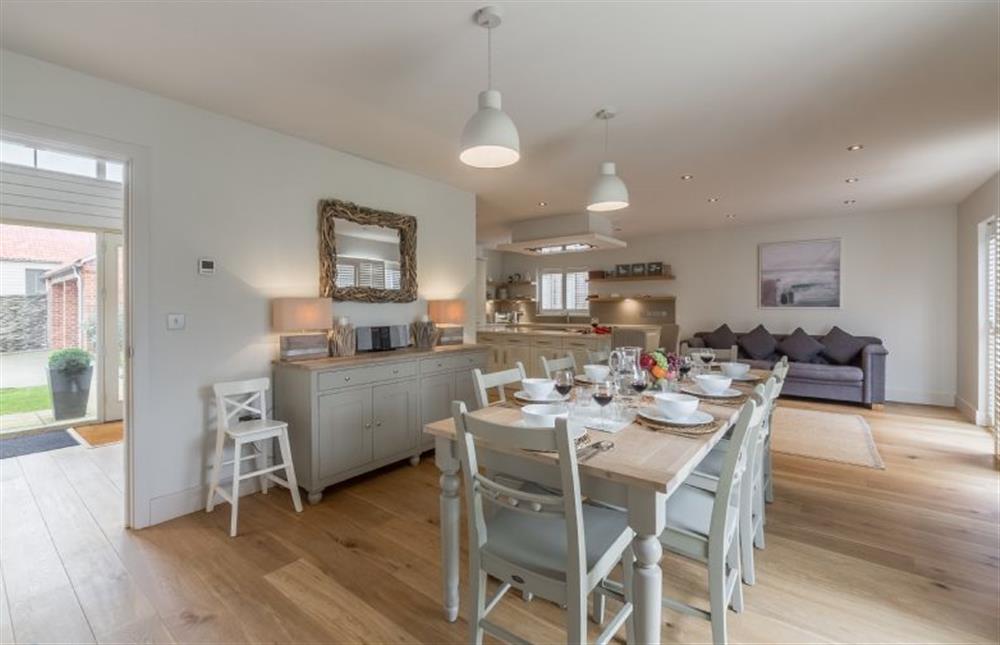 Ground floor: Dining area looking towards kitchen and comfy sofa at Anchorage, Brancaster near Kings Lynn