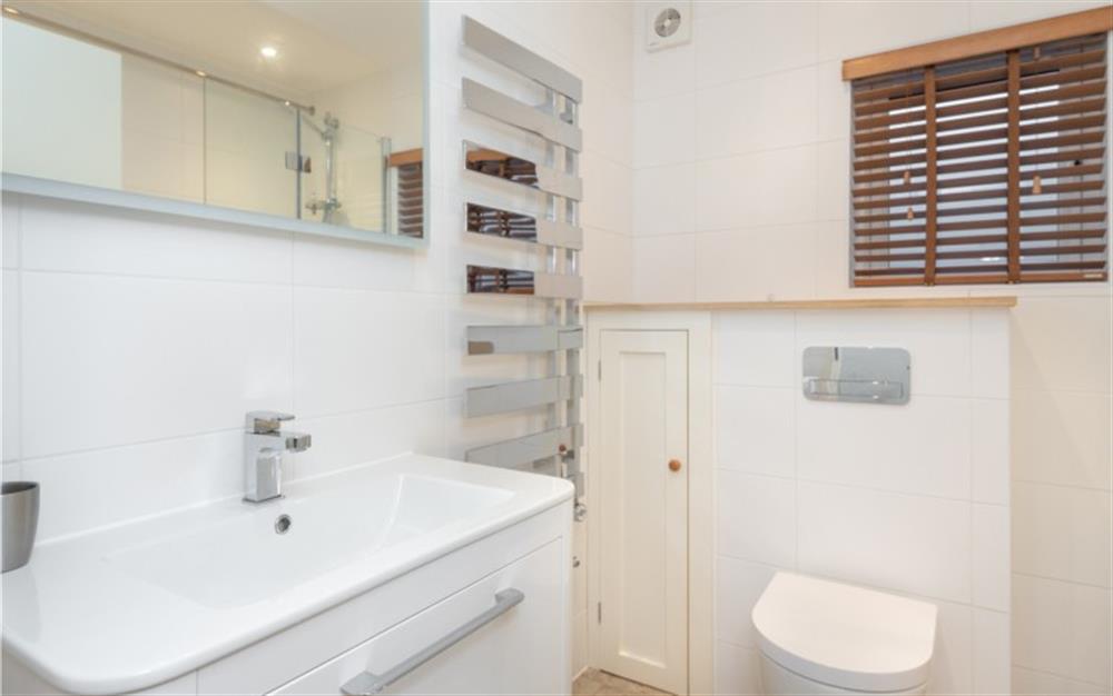 The bathroom, with both bath and overhead shower, is beautifully contemporary. There is also a separate cloakroom with a WC and hand basin. at Anchors Aweigh in Helford Passage