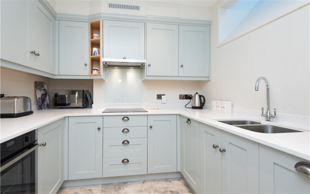 The brand new kitchen, in a relaxing soft grey, is fully equipped with everything you'll need on holiday. at Anchors Aweigh in Helford Passage
