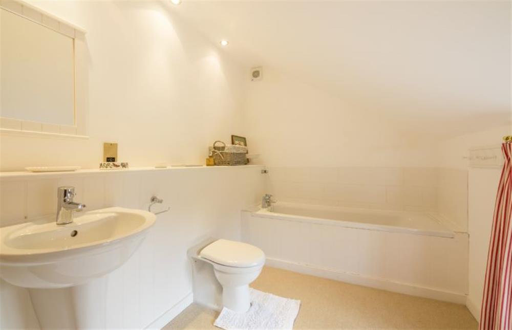 First floor: Family bathroom with bath, basin and WC at Angel Cottage, Great Walsingham