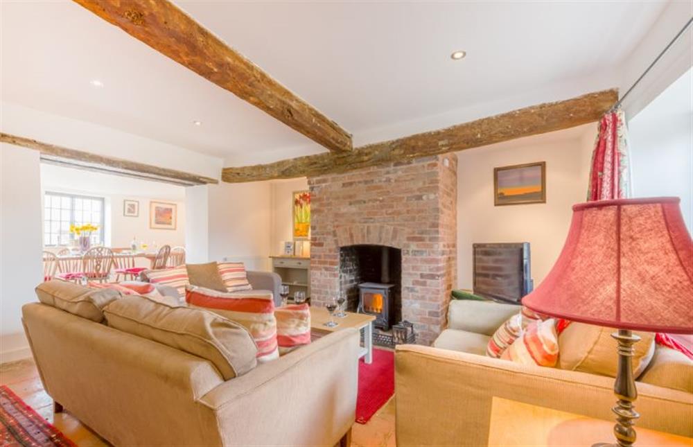 Ground floor: Sitting room with wood burning stove at Angel Cottage, Great Walsingham