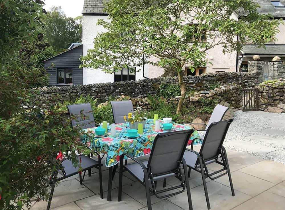 Paved patio with outdoor furniture at Angle Tarn Cottage in Ambleside, North Yorkshire