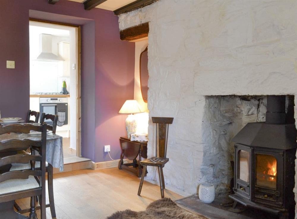 Spacious dining room with wood burner at Annies Cottage in Edinbane, near Portree, Isle Of Skye