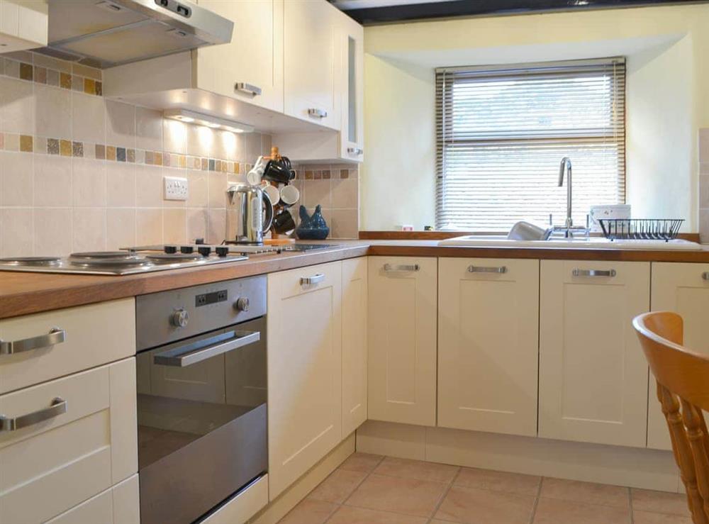 Well appointed kitchen with modest dining area at Annies Cottage in Millom, Cumbria