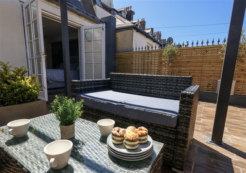 Enjoy a cup of tea on the patio at Apartment 1, Weymouth
