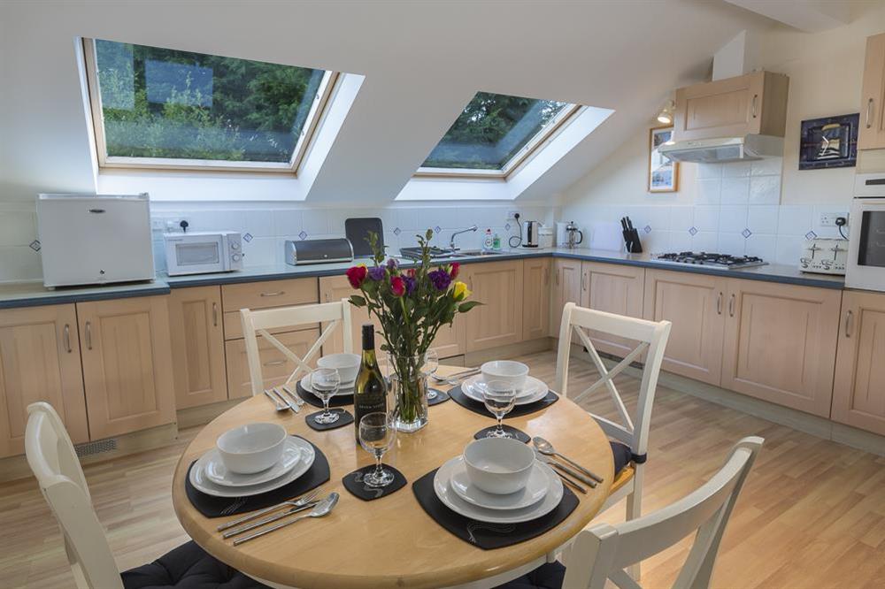 Large circular dining table with four chairs at Apartment 19, Bolt Head in South Sands, Salcombe