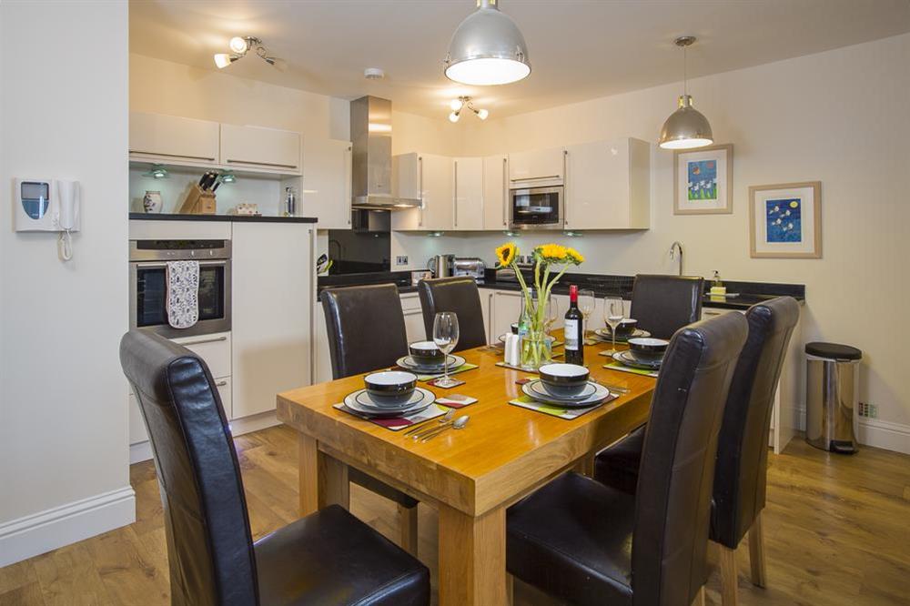 Oak dining table with six leather chairs at Apartment 2, At The Beach in Torcross, Nr Kingsbridge