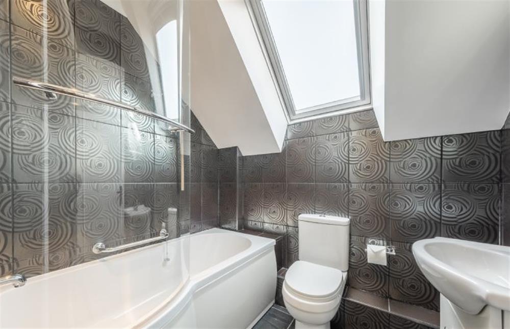 Bathroom with bath and shower over, wash basin and WC at Apartment Eight by the Sea, Sheringham