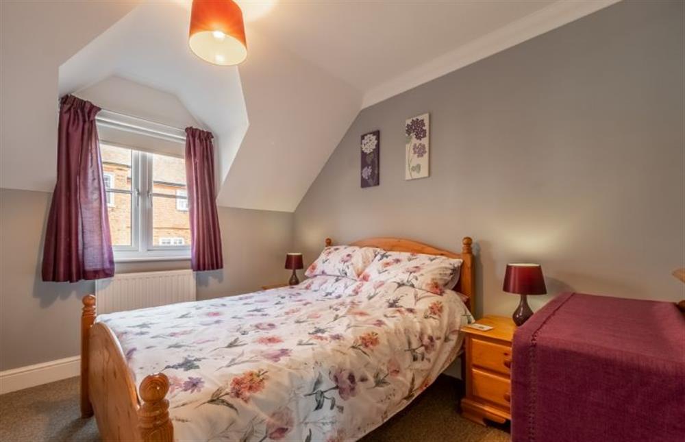 Master bedroom with a double bed at Apartment Eight by the Sea, Sheringham