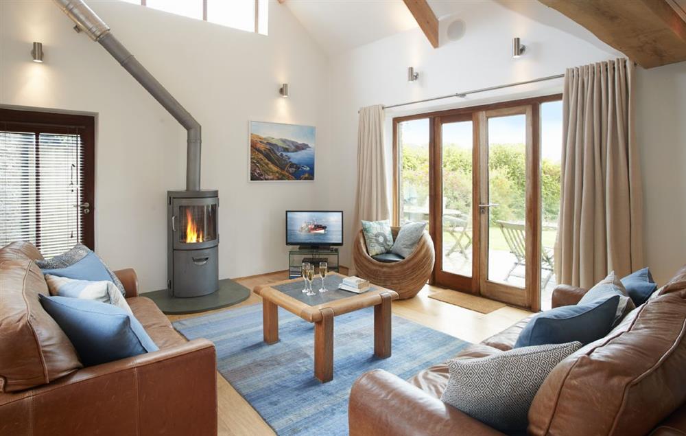 Double height sitting room with wood burning stove (photo 2) at Apple Barn, East Portlemouth