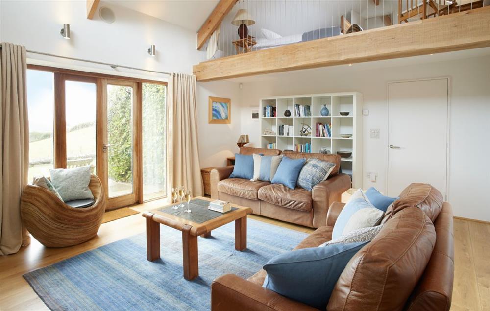 Double height sitting room with wood burning stove at Apple Barn, East Portlemouth