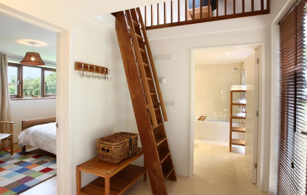 Hall with steep wooden ’ladder’ staircase to first floor loft with accommodation for 2 extra older children/teenagers using futon beds. This area leads to gallery bedroom