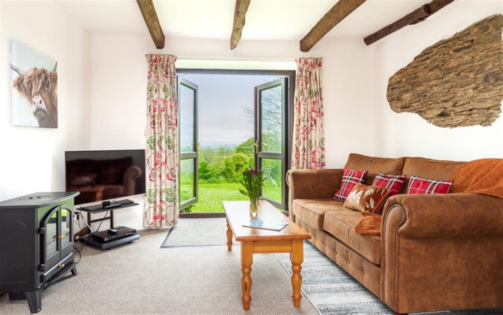 Lounge with access to garden, with lovely countryside views at Apple Cottage in Looe