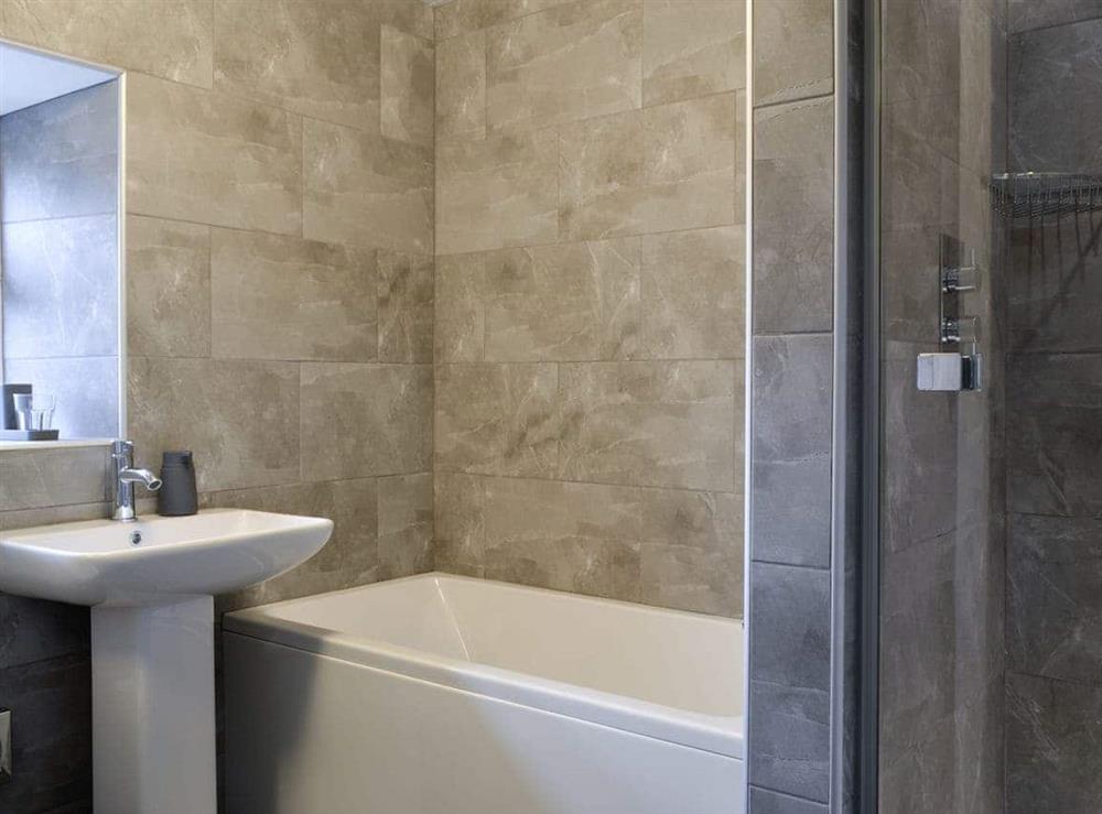 Family bathroom with bath and separate shower cubicle at Apple Tree Cottage in Bassenthwaite, near Keswick, Cumbria