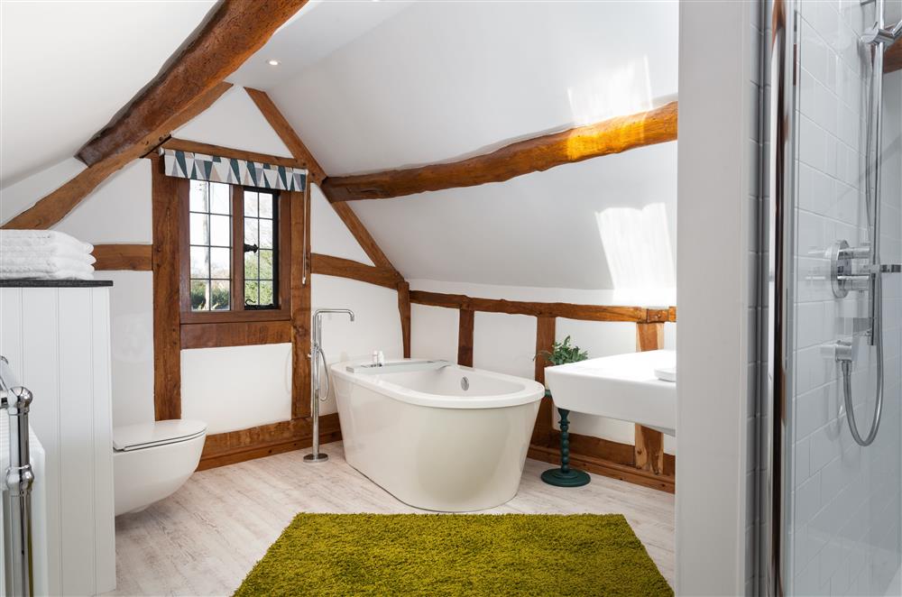 The family bathroom with free-standing bath and walk-in shower cubicle  at April Cottage, Eckington