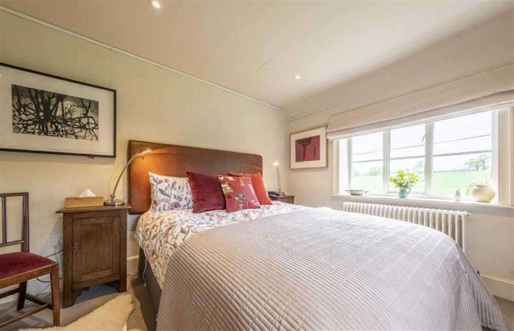 A lovely bedroom with more views over the gardens at Art Farmhouse, Saxmundham