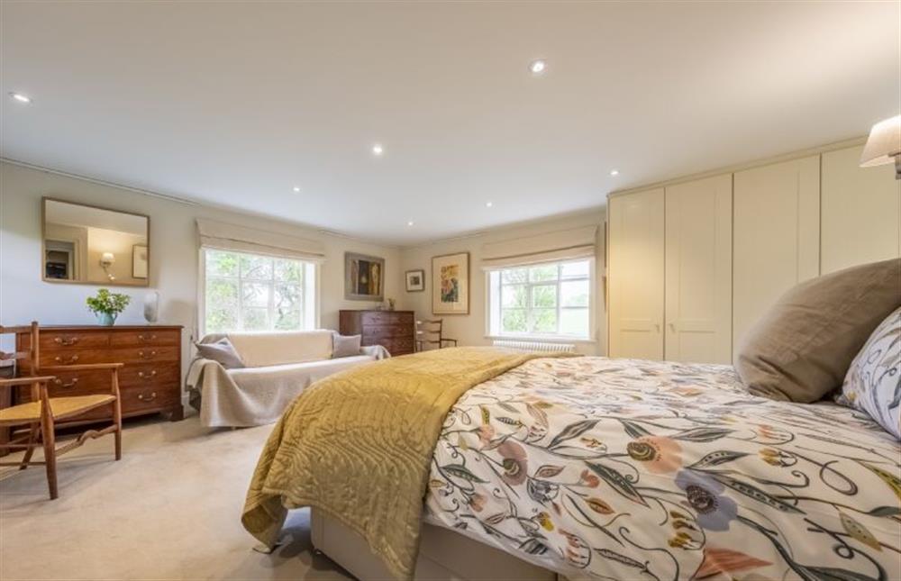 Master bedroom with a large en-suite bath and shower room at Art Farmhouse, Saxmundham