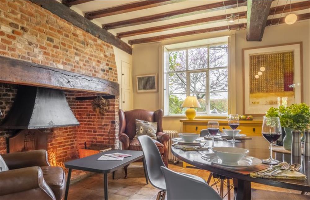 Open fire beside the dining table at Art Farmhouse, Saxmundham